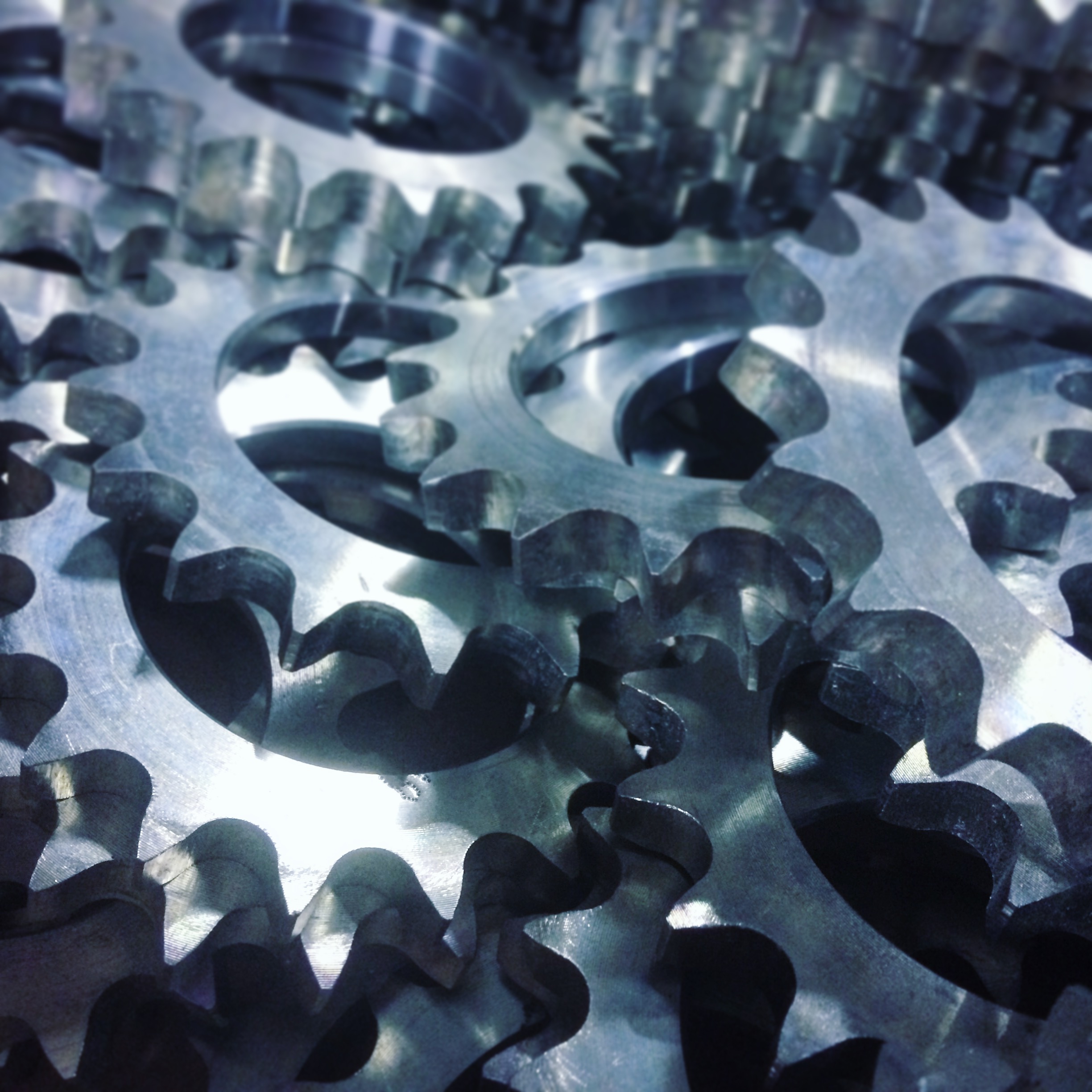 Industrial chain sprocket assortment on a workshop surface